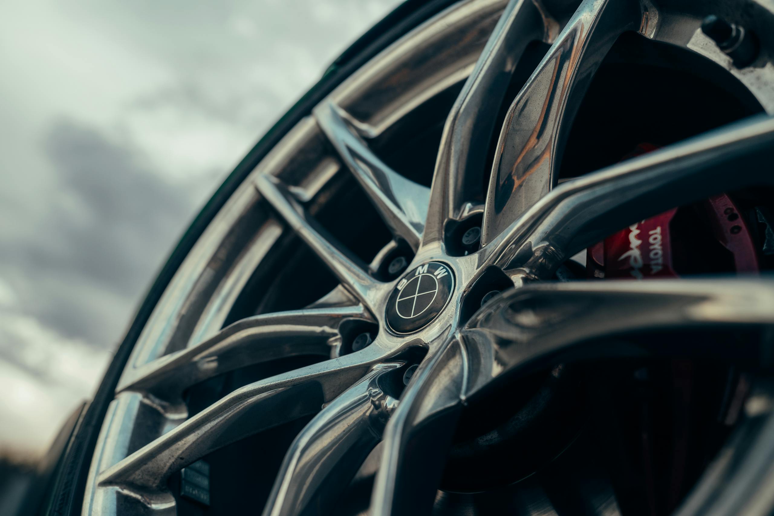 Detailed image of a car alloy wheel, showcasing modern design with sharp lines and sleek appearance.